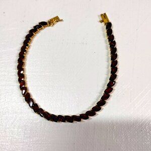 10K gold garnet tennis bracelet.